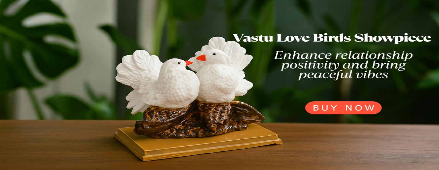 Decorative Vastu Love Birds Showpiece on a wooden surface with green foliage in the background.